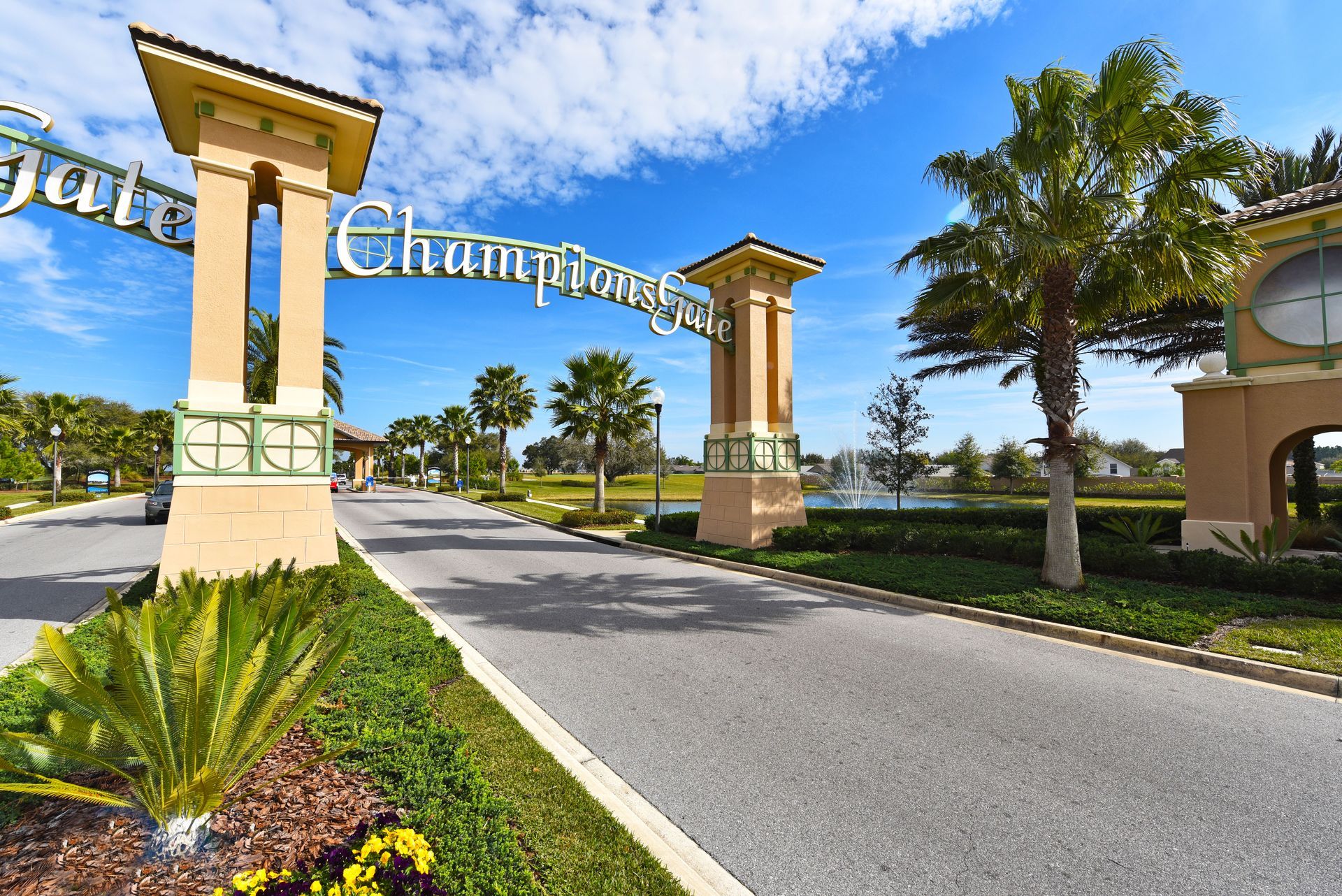 The palm-lined entrance to the ChampionsGate resort community in Davenport, Florida, under a bright sky