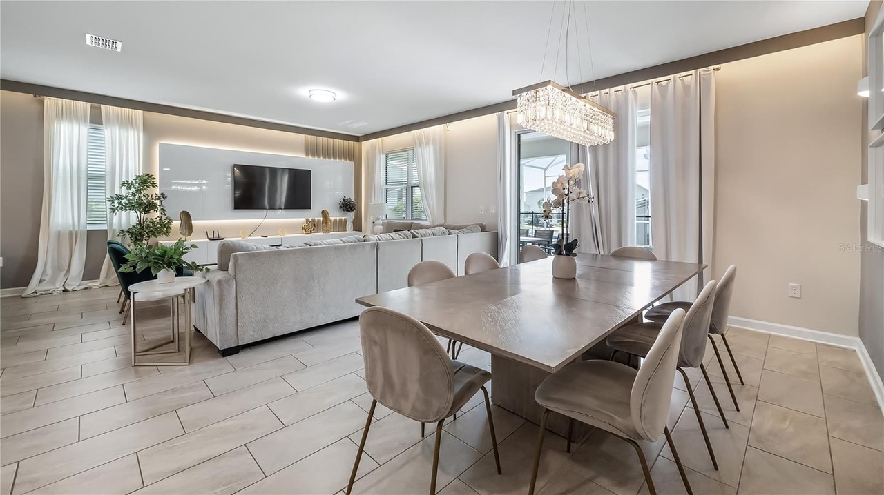A bright open-plan dining area with a large table seating a big family group