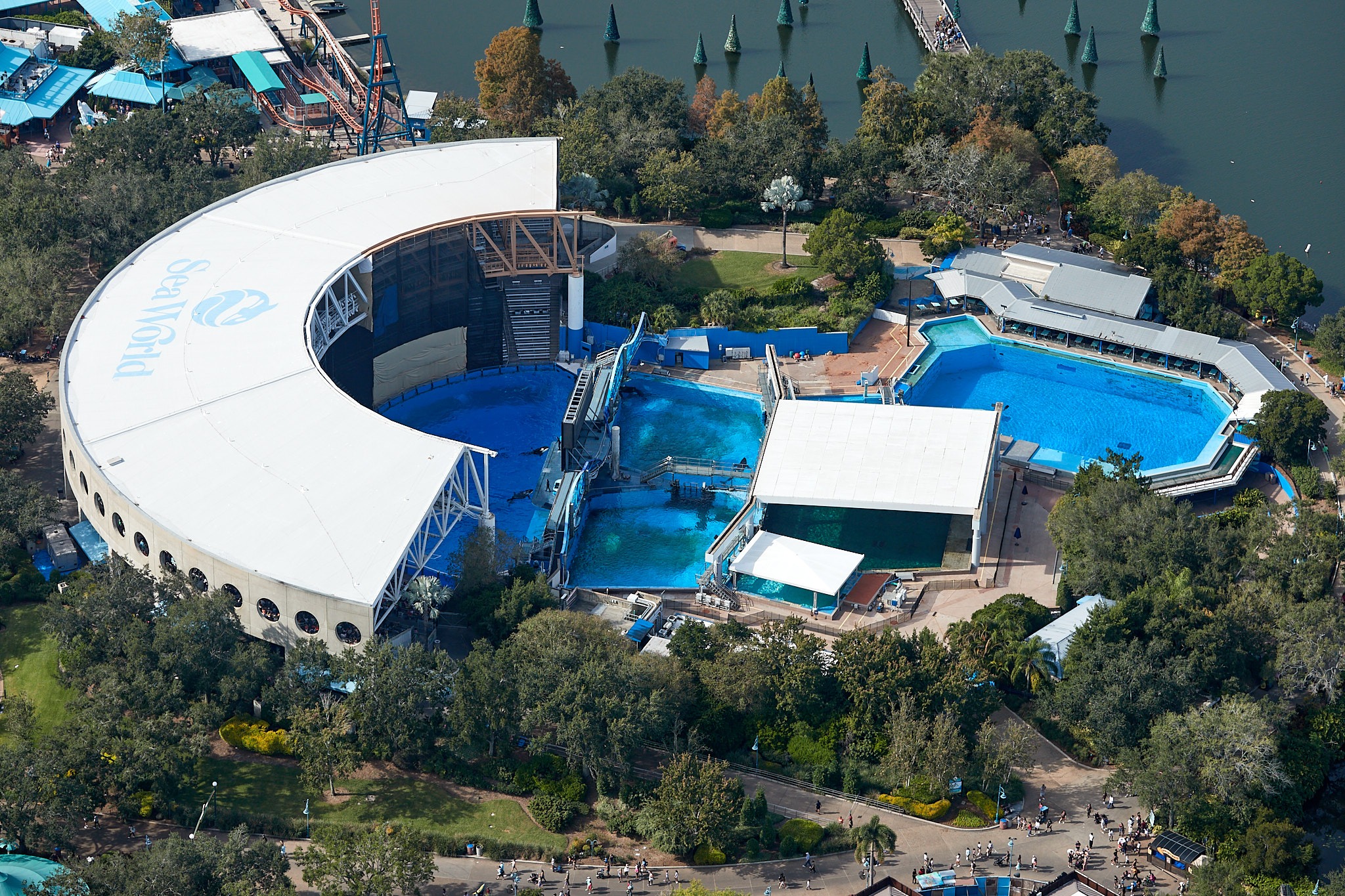 An aerial view over a marine theme park in Orlando, with lagoons, pools and green landscaping
